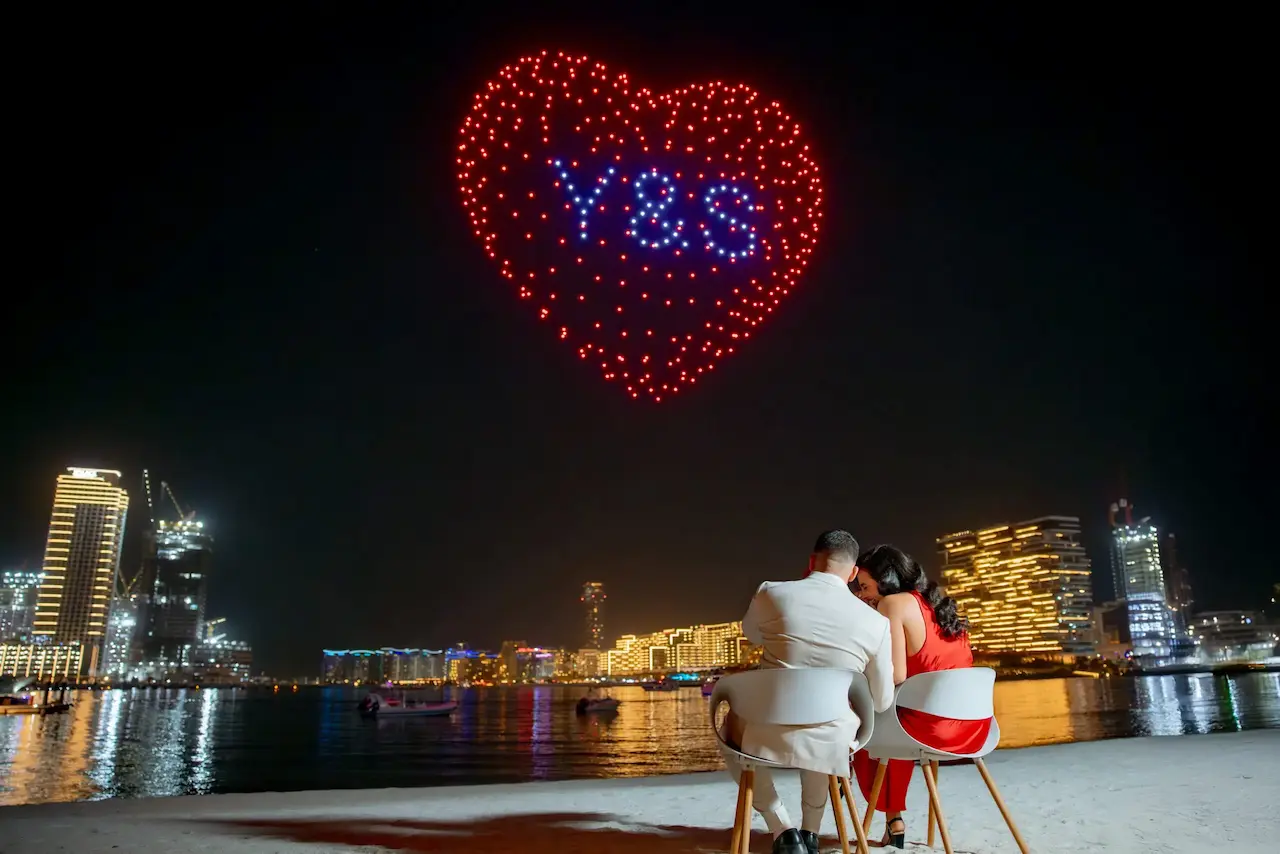 Bespoke proposal with drone light show spelling Yes over Dubai Marina at night